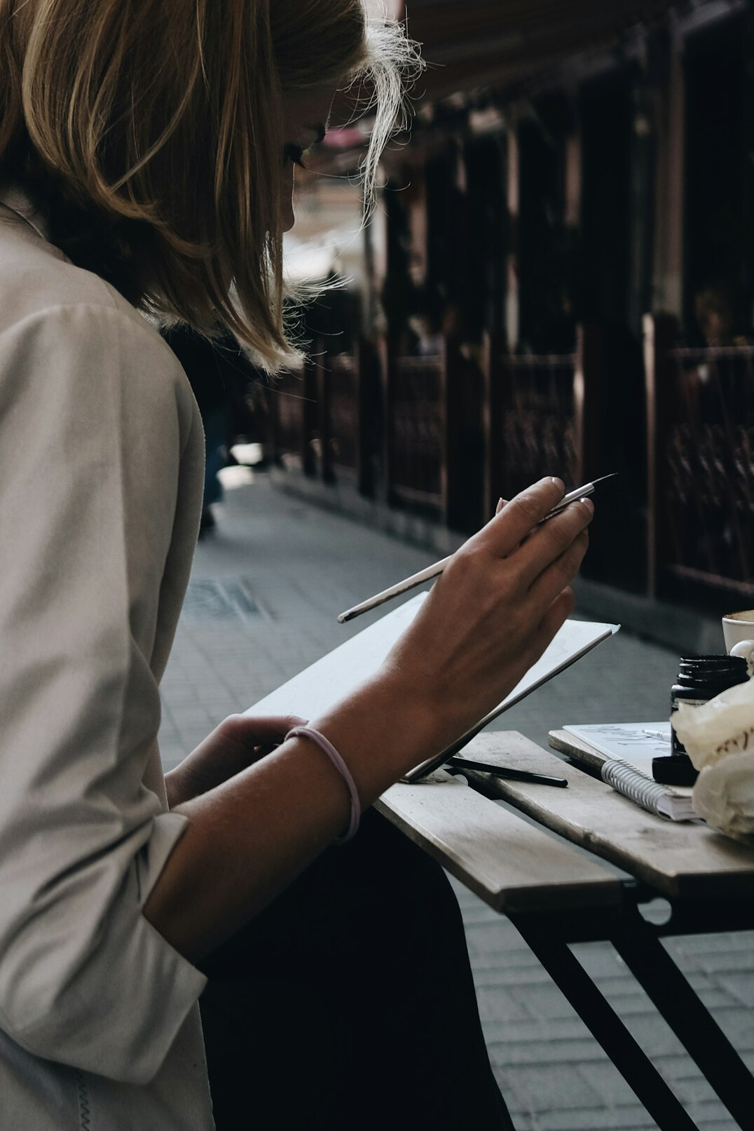 writer taking notes in cafe